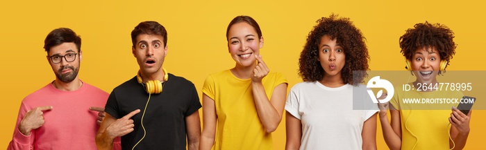 Horizontal shot of three ethnic women and two men gather together, look at camera with happiness, puzzlement and shock, use modern innovative technologies, listen music from playlist in headphones