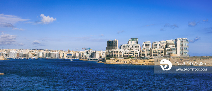 Malta Valletta. Modern Sliema multi-storey buildings, blue sea and sky background