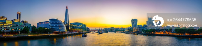 London skyline panorama at sunset, seen from Tower Bridge