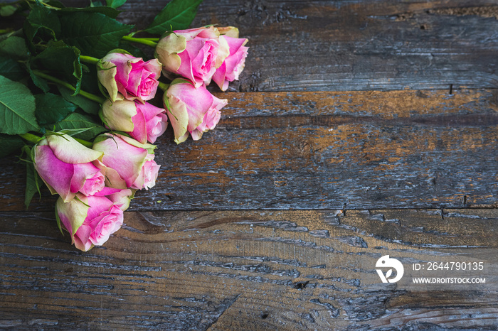 Soft pink green roses on a rustic wooden background - for valentines day, mothers day, birthday, wed