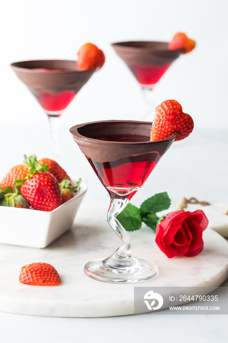 Bright red Valentines Day cocktails with chocolate dipped rims.