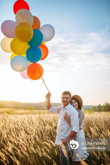 Husband and wife walks with bunch of balloons