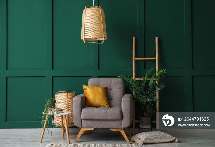 Interior of stylish living room with armchair, ladder and hanging lamp