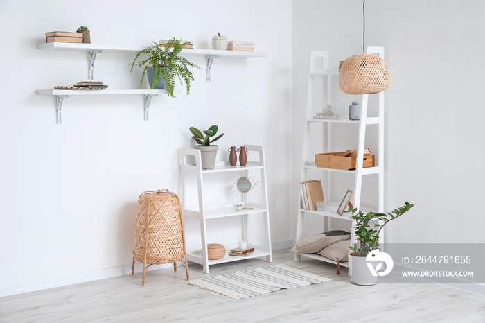 Modern book shelves near white wall in room