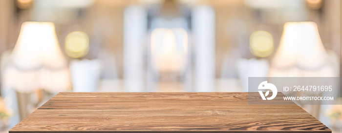 Perspective Wood table at lamp in restaurant blur background.coffee shop with bokeh light,Mockup  ba