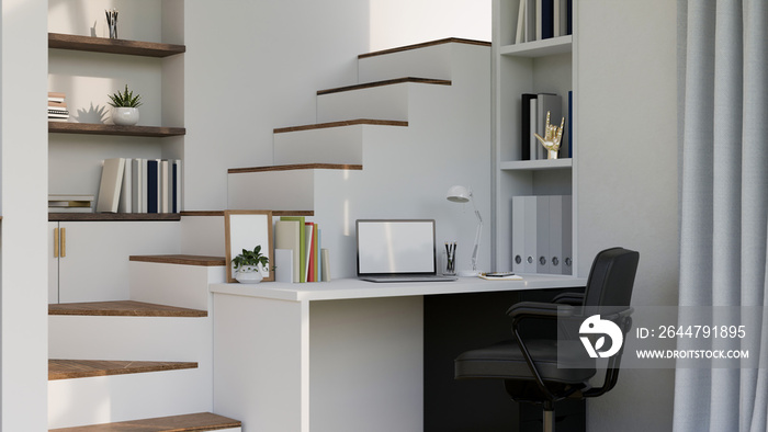 Home working space in minimal white style with laptop on white desk against the staircase