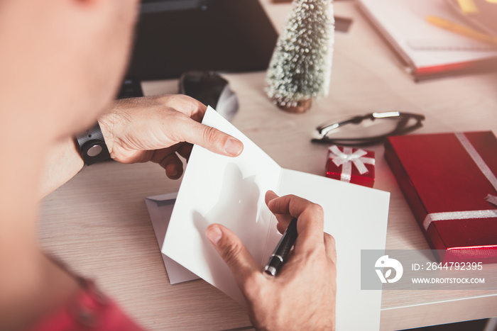 Man writing greeting card