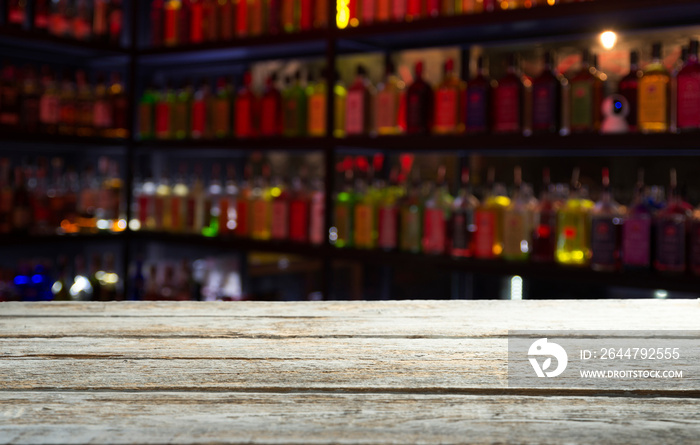 Classic bar counter with bottles in blurred background