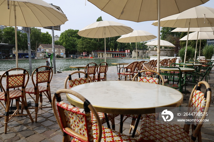 parisian cafe terrace on canal embankment