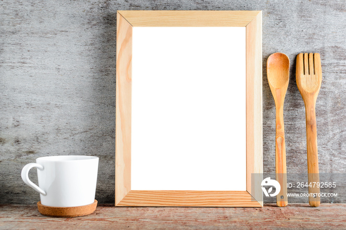 empty wooden frame with isolated white background and kitchen accessories on a wooden table.