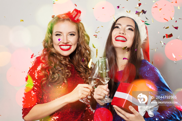 Christmas women laughing. Winter fashion model girls on abstract bokeh glitter sparkle party backgro