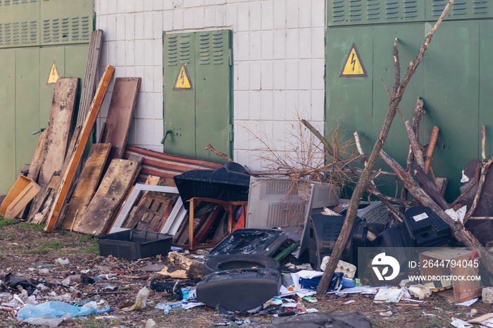 Old broken furniture, old TVs at the garbage dump near the electrical building