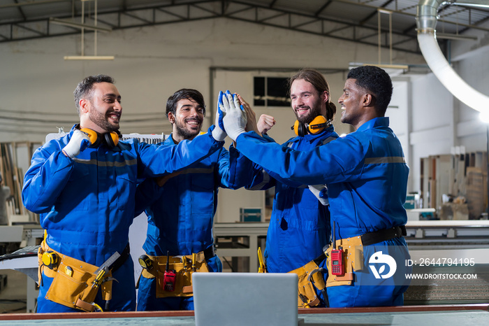 Group of male technician workers working and holding hands together in the industry factory. Team of