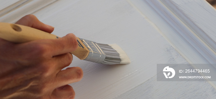 a brown kitchen cabinet is painted with white chalk paint