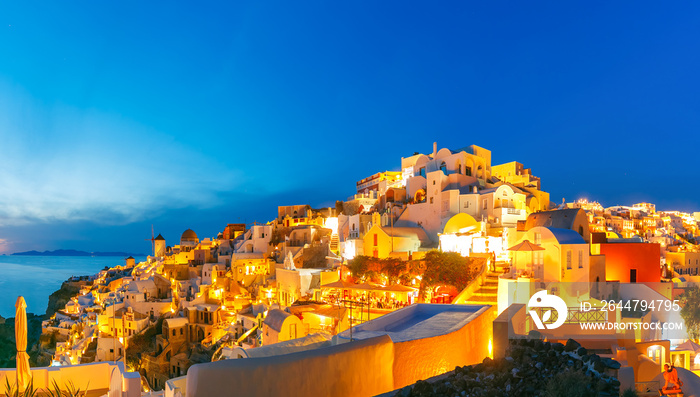 Panoramic famous view, Old Town of Oia or Ia on the island Santorini, white houses and windmills at 