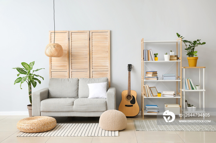 Interior of modern living room with shelf unit and sofa