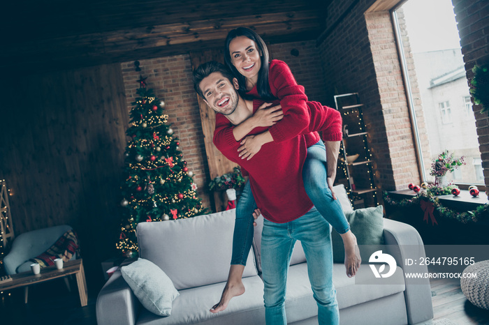 Portrait of romantic two youth hug piggyback on christmas x-mas party event wearing red jumper denim