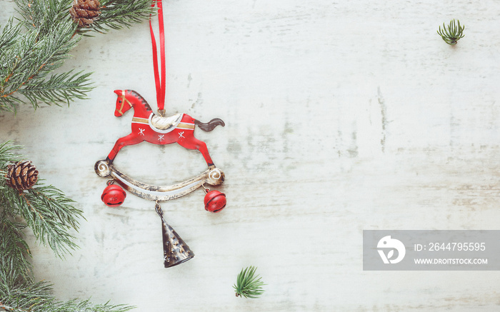 Christmas background. Toy horse with Christmas tree on table, Top view, vintage toned image, blank s