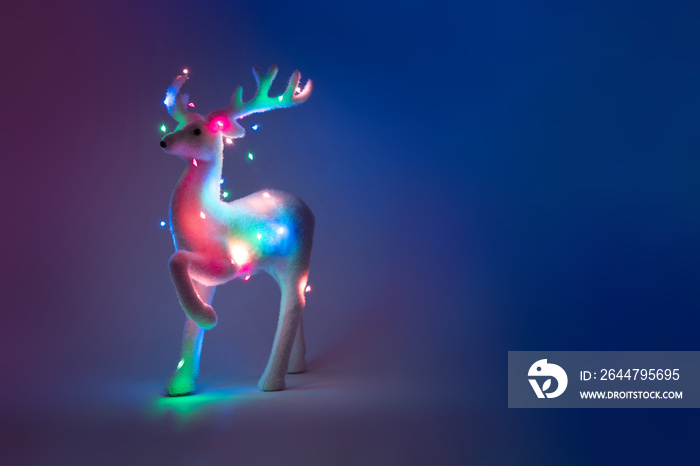 Neon reindeer tree with Christmas lights. Minimal New Year concept.