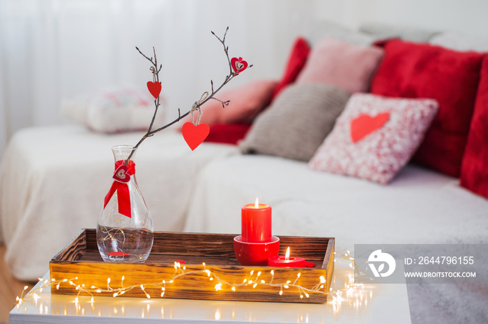 Burning candles on white table in interior. Valentines day conce