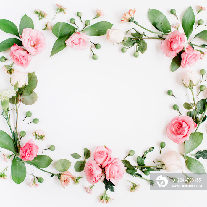 Round frame made of pink and beige roses, green leaves, branches on white background. Flat lay, top 