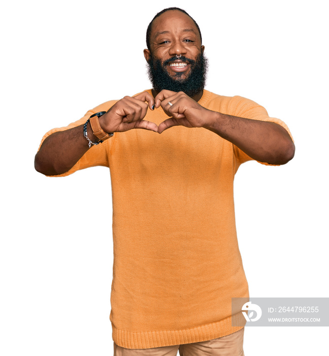 Young african american man wearing casual clothes smiling in love showing heart symbol and shape wit