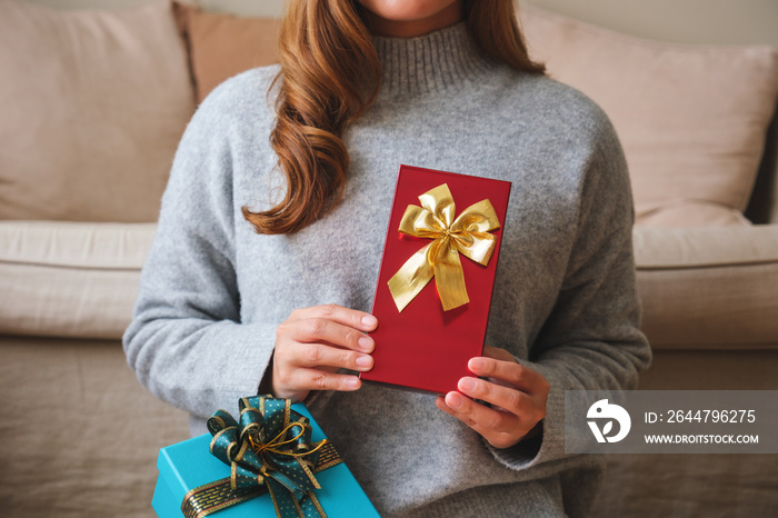 Closeup image of a young woman holding present boxes