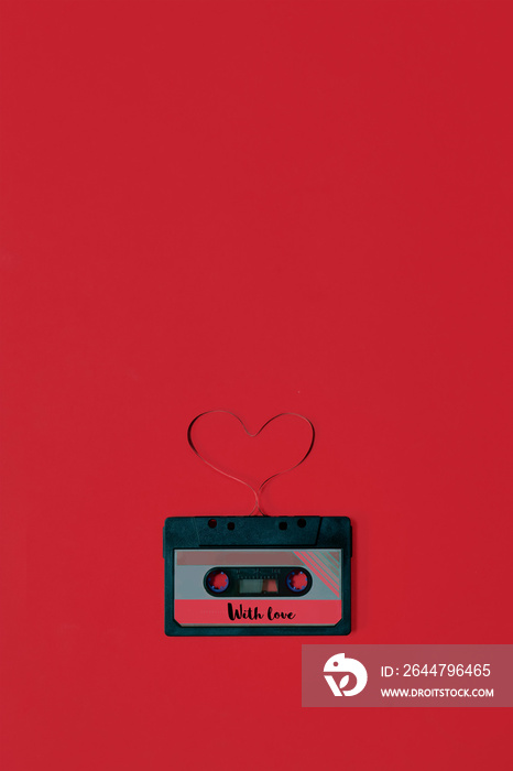 Valentines day card audio cassette with tape in shape of heart red background