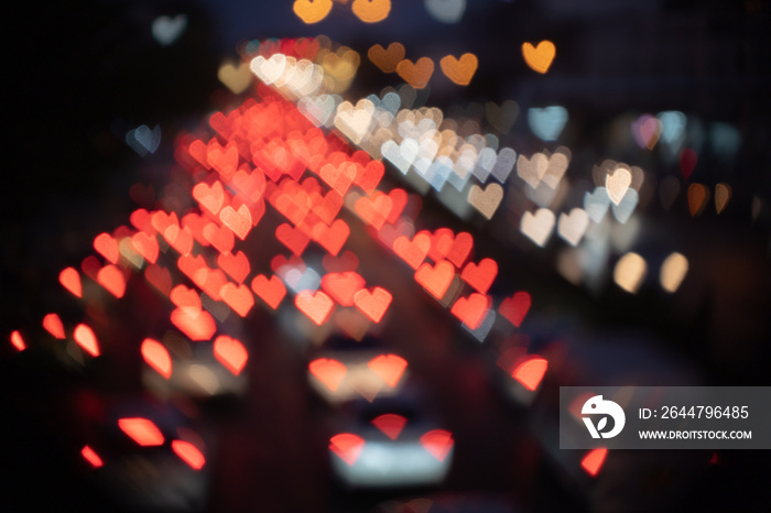 Heart-shaped Bokeh of lights from cars on the road at night.