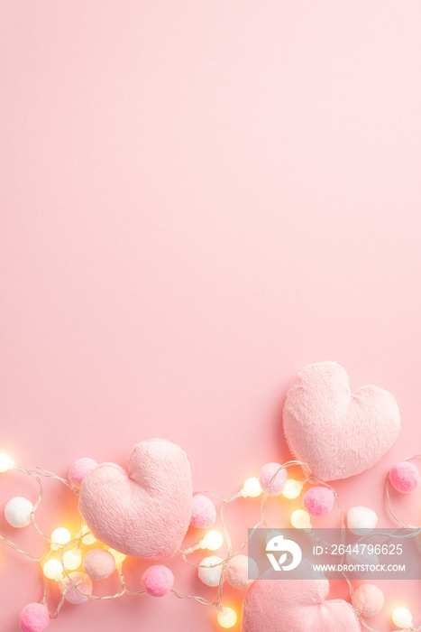 Valentines Day concept. Top view vertical photo of fluffy heart shaped pillows light bulb garland a