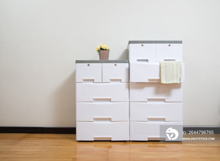 Stacks of white plastic cabinets with drawers