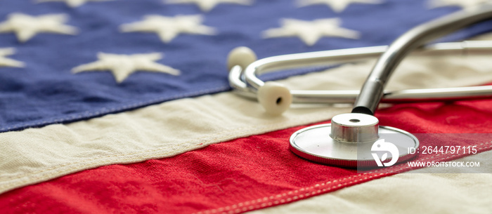 US health. Medical stethoscope on a USA flag, closeup view.