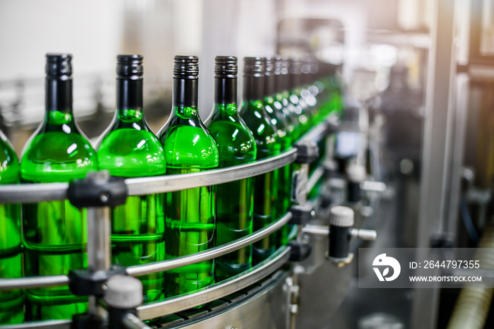 Bottling and conveyor line or belt at winery factory, Wine bottles filling production.