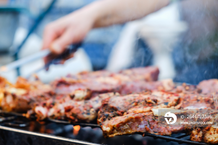 BBQ Roasted Pork Meat With herb spice On The Hot Charcoal Grill With Smoke.