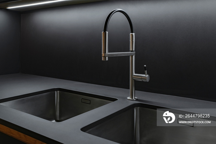 Sink and faucet in the kitchen in black