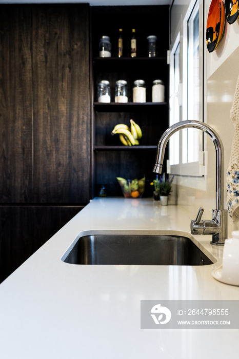 Vertical shot of a modern kitchen interior with a sink