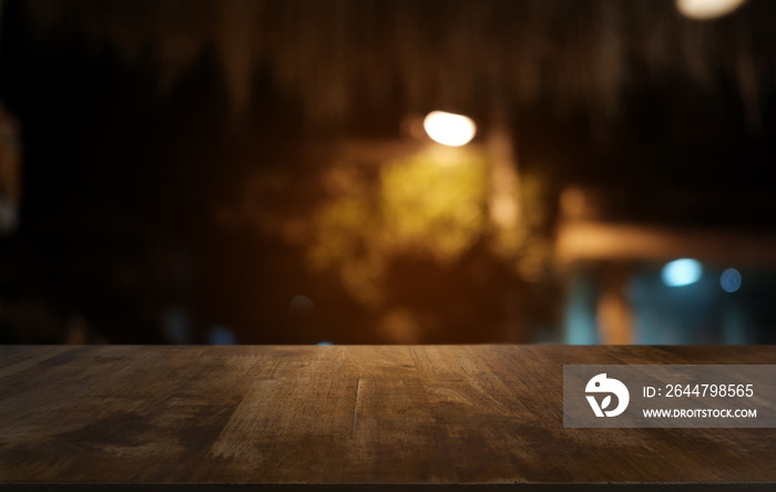 Empty dark wooden table in front of abstract blurred bokeh background of restaurant . can be used fo