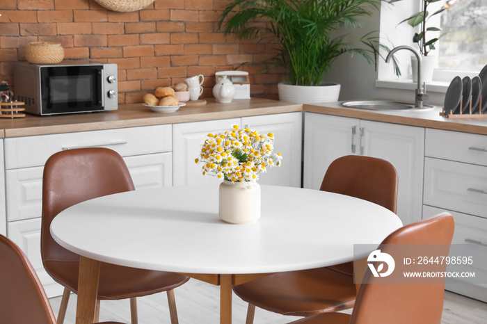 Dining table in interior of modern kitchen