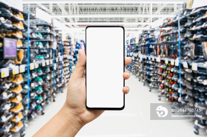 Mockup smartphone with sport shoes on shelves in sneakers shop modern sports supermarket background.