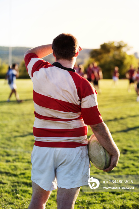 Man holding rugby ball during game