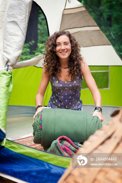 Woman rolling sleeping bag