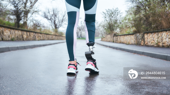 Morning workout. Cropped photo of of disabled athlete woman in sportwear with prosthetic leg standin