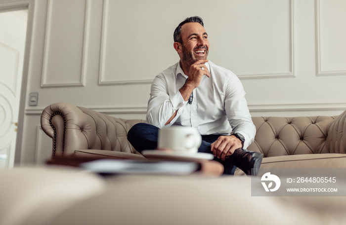 Mature businessman staying in luxurious hotel room