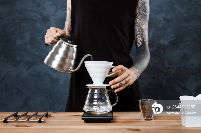 Male barista brewing coffee. Alternative method pour over.