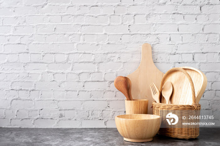 wooden kitchenware on white brick wall texture background.