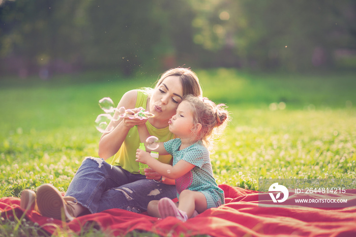 Happy Childhood – Mother and child blows soup foam and make bubbles .