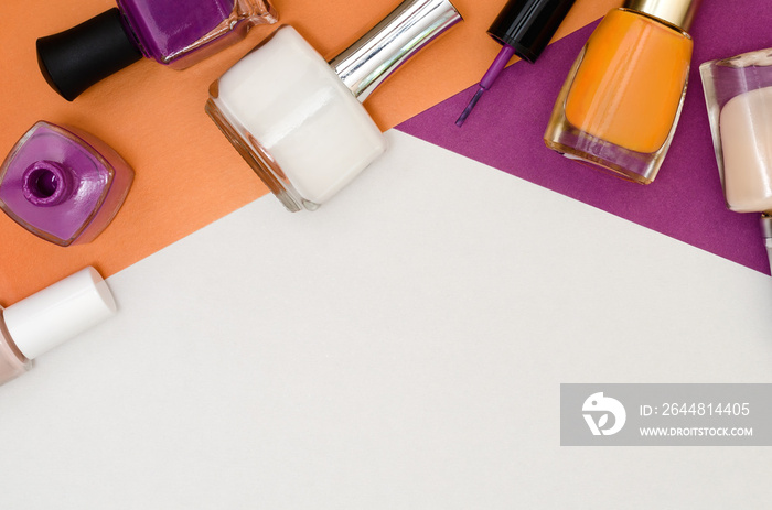 Bottles of nail polish. Orange, purple and white color.