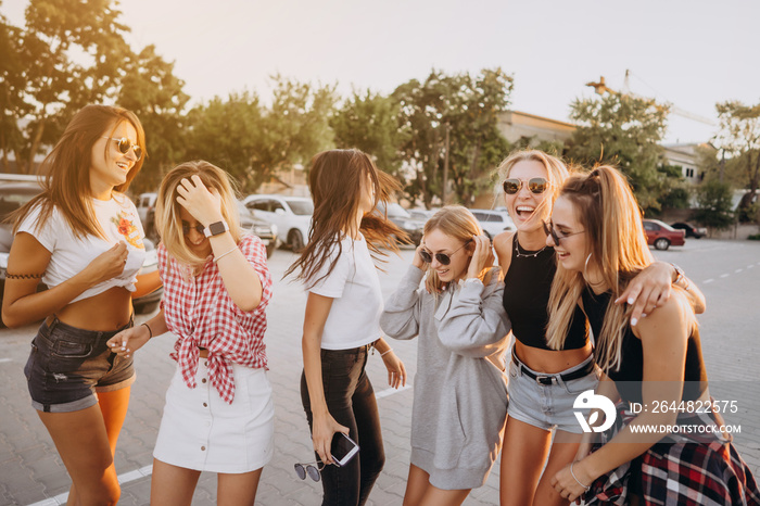 Six young women dance in a car park