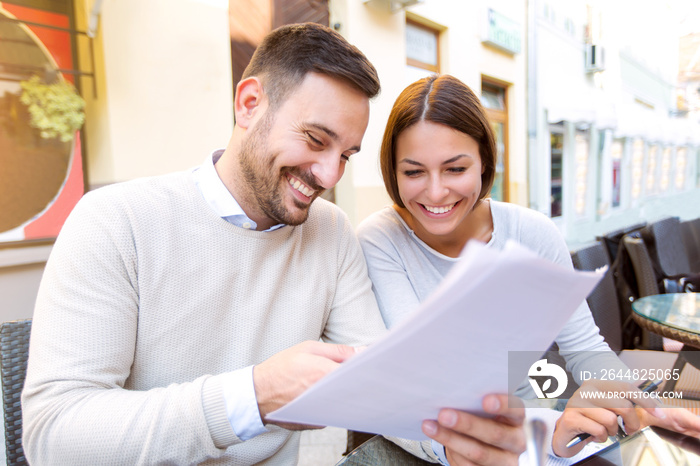 Young couple interacting while having coffee in cafe