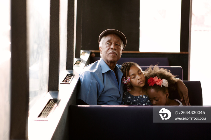 Girls sleeping on grandfathers shoulder